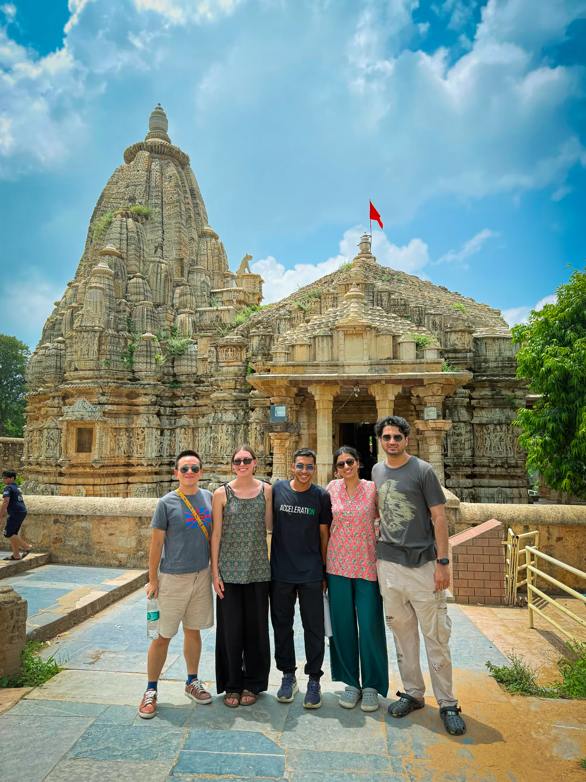 A group of travellers standing before an intricately carved temple in Rajasthan